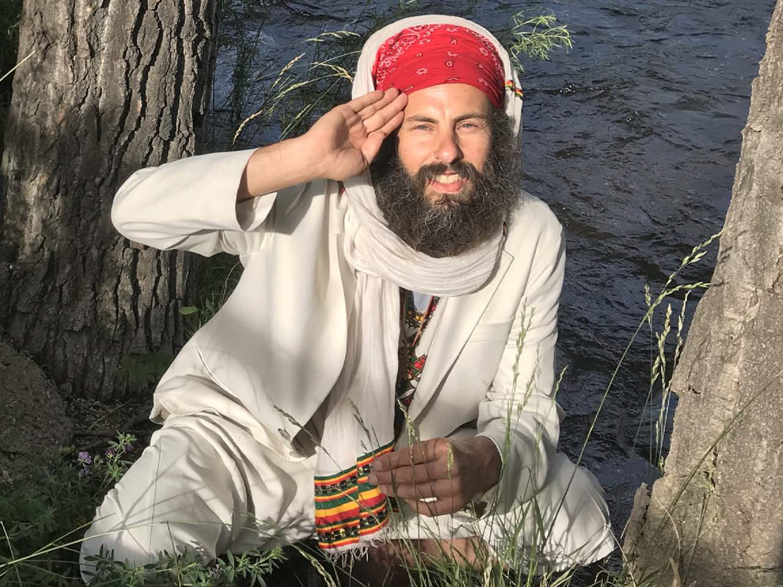 Sean Bookman (Shankara) in traditional white robes by the water