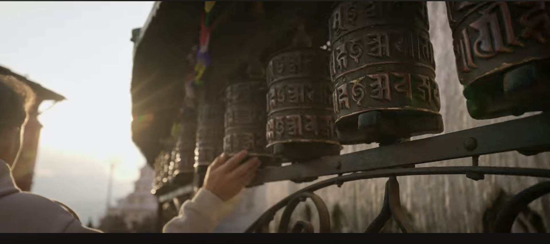 Prayer wheels spinning at sunset